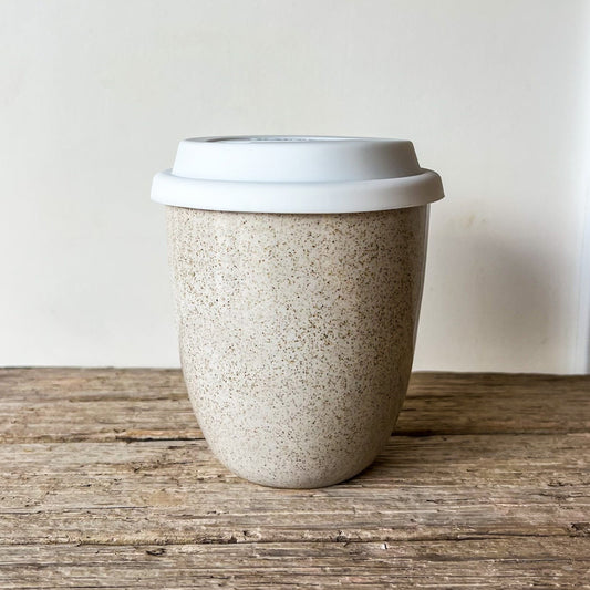 Speckled ceramic tumbler with a white lid 