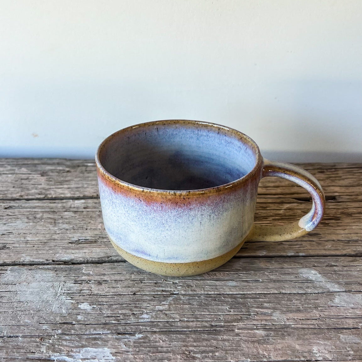 Ceramic mug with a rustic finish on a wooden surface