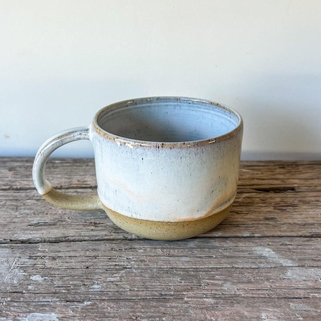 Ceramic mug on a wooden surface with a white background